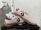 Pair of cream Converse trainer-style sneakers with pale pink panels, plum accents, and gum-colored outsoles