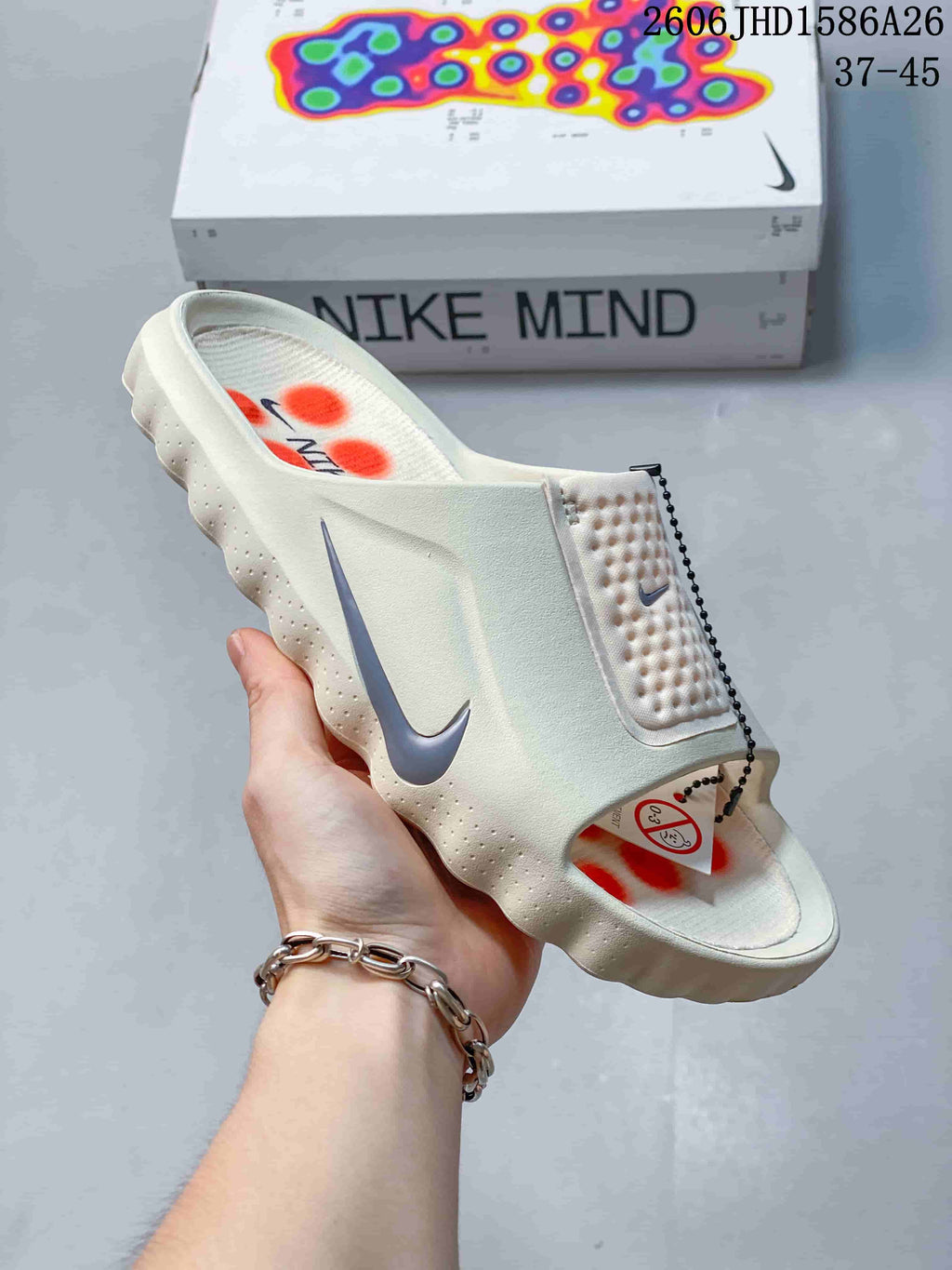 Close-up of a Nike Mind 001 slide showing the textured strap and sculpted sole