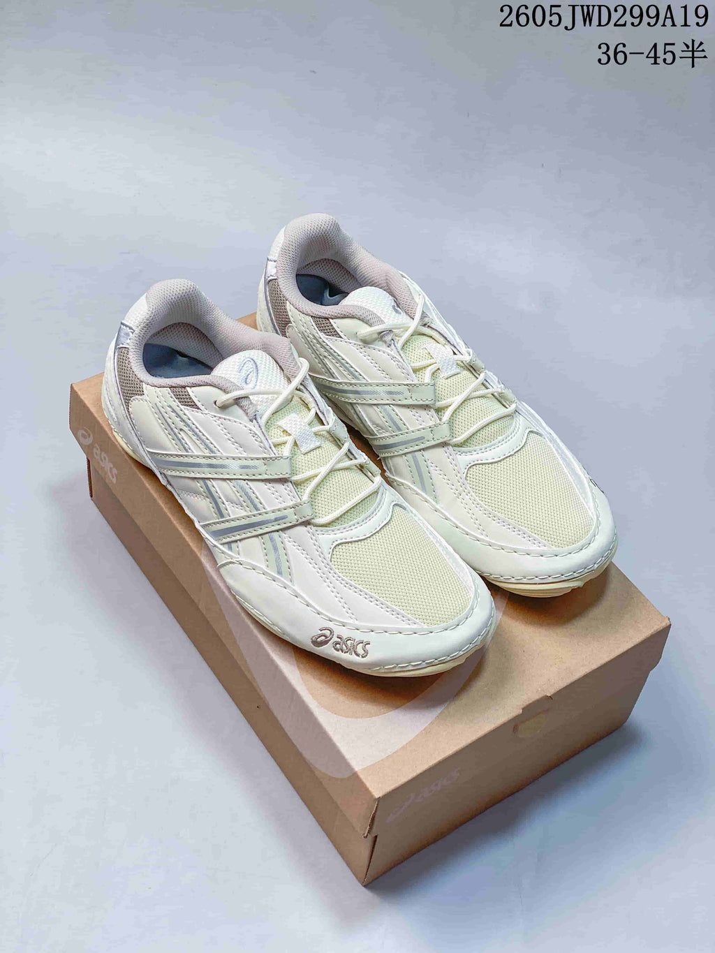 Pale ivory ASICS GEL-1130 sneakers displayed on a shoebox.