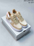 Pair of tan and cream Nike Air Force 1 ’07 low-top sneakers on a shoe box; printed size range 36–45.