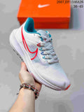 White Nike Air Zoom Pegasus 39 sneaker with red and blue accents, shown from the side with an orange shoe box behind it.
