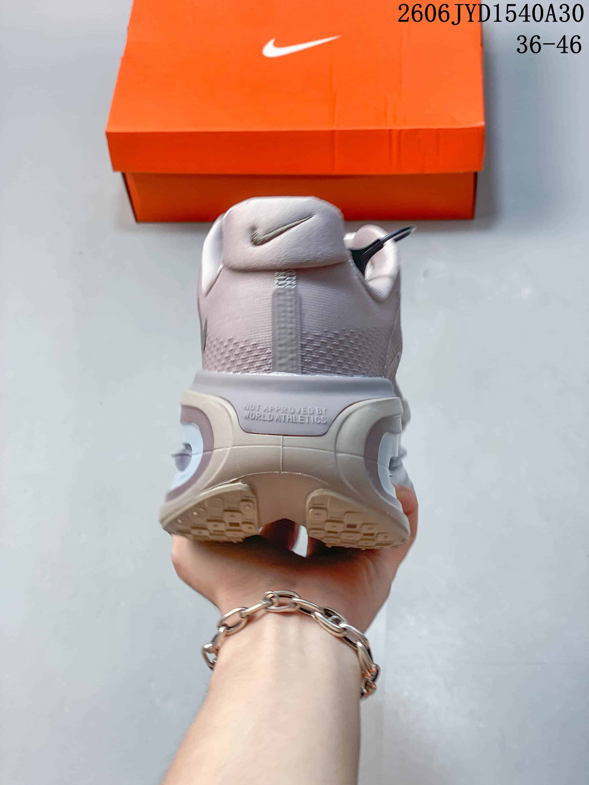Rear view of a mauve-gray sneaker showing the heel and sculpted sole