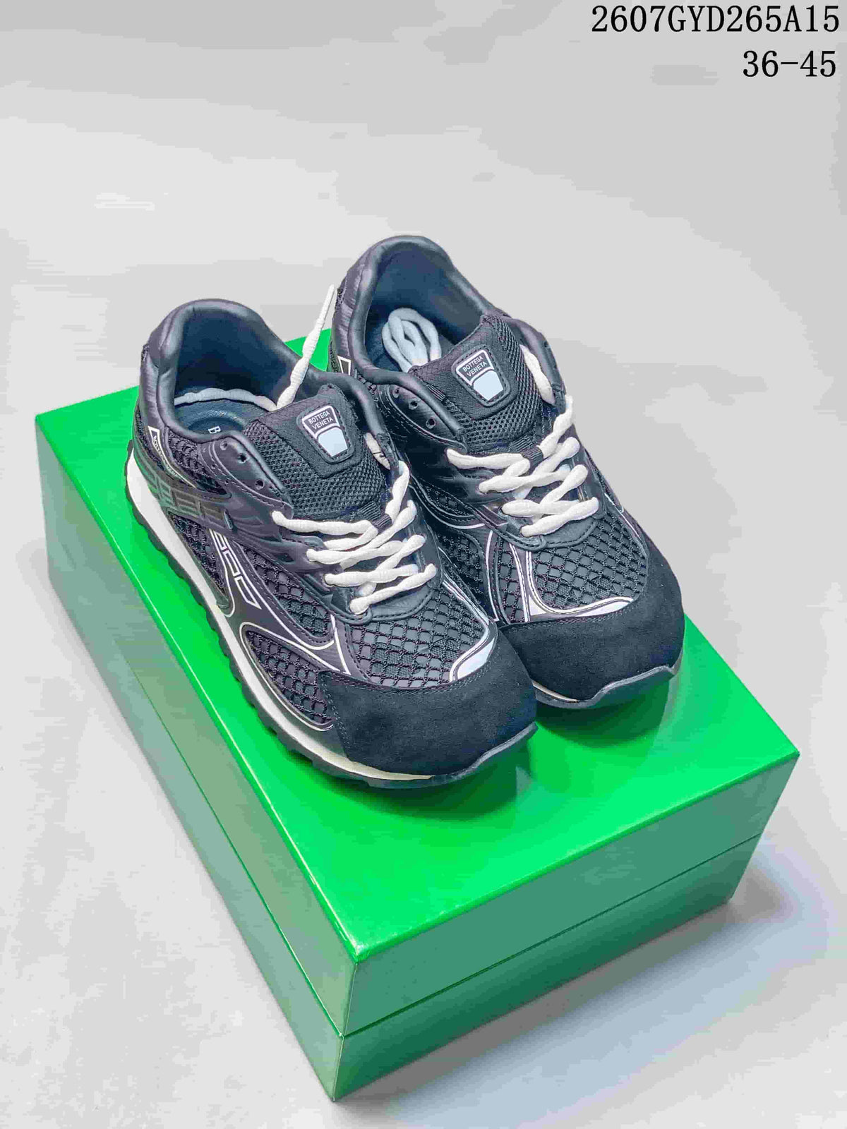 Pair of black and white Bottega Veneta Orbit sneakers displayed on a green box, with the style code and EU size range visible above.