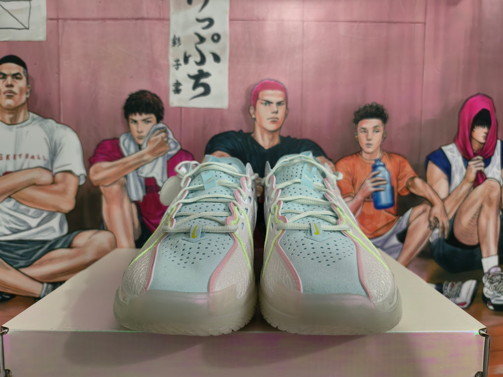 Front view of light gray Nike basketball shoes with pale blue, pink, and lime accents