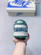 Rear view showing the green heel tab, white midsole, patterned blue heel panel and green outsole.