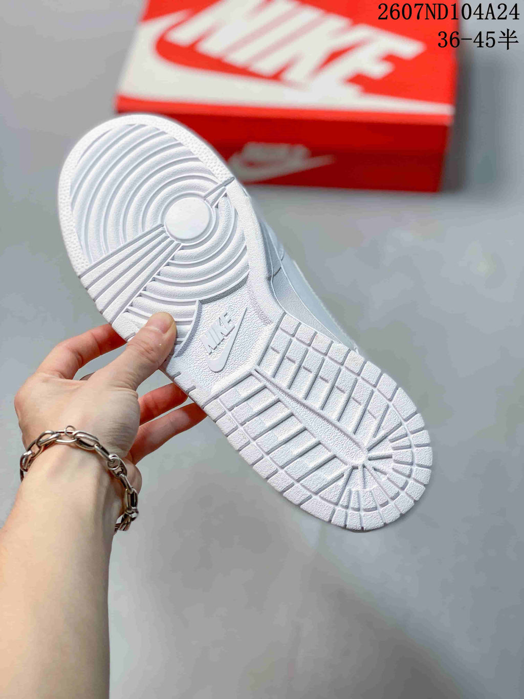 Close-up of the white textured outsole showing circular and geometric traction patterns.