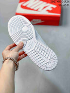 Close-up of the white textured outsole showing circular and geometric traction patterns.