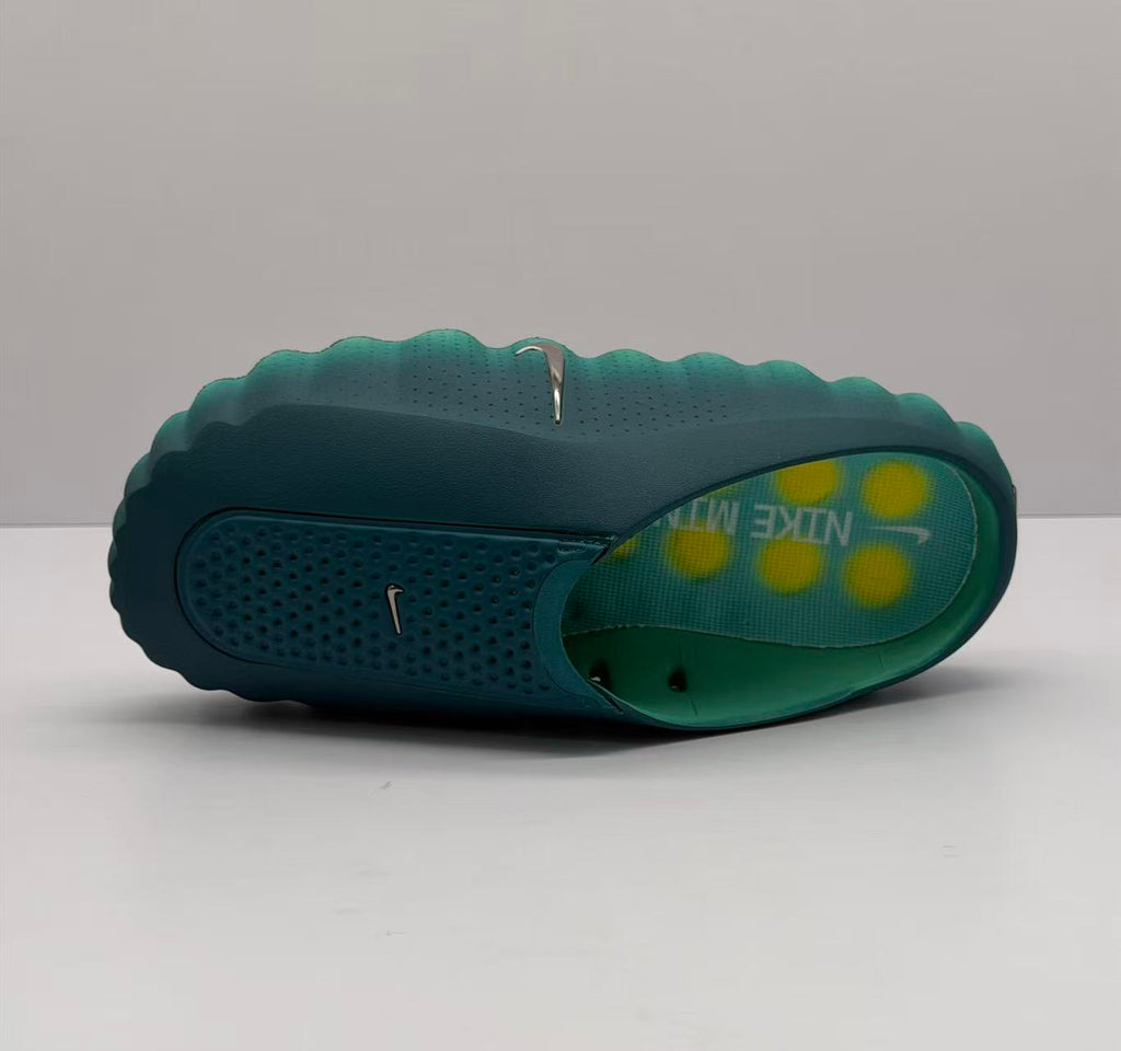 Top and side view of one green slide showing the perforated upper and branded footbed.