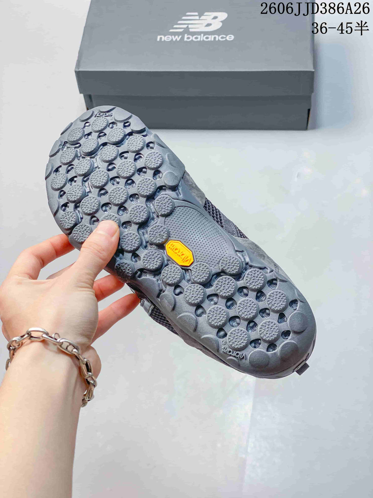 Underside of the grey sneaker showing the patterned lugged outsole and yellow Vibram branding.