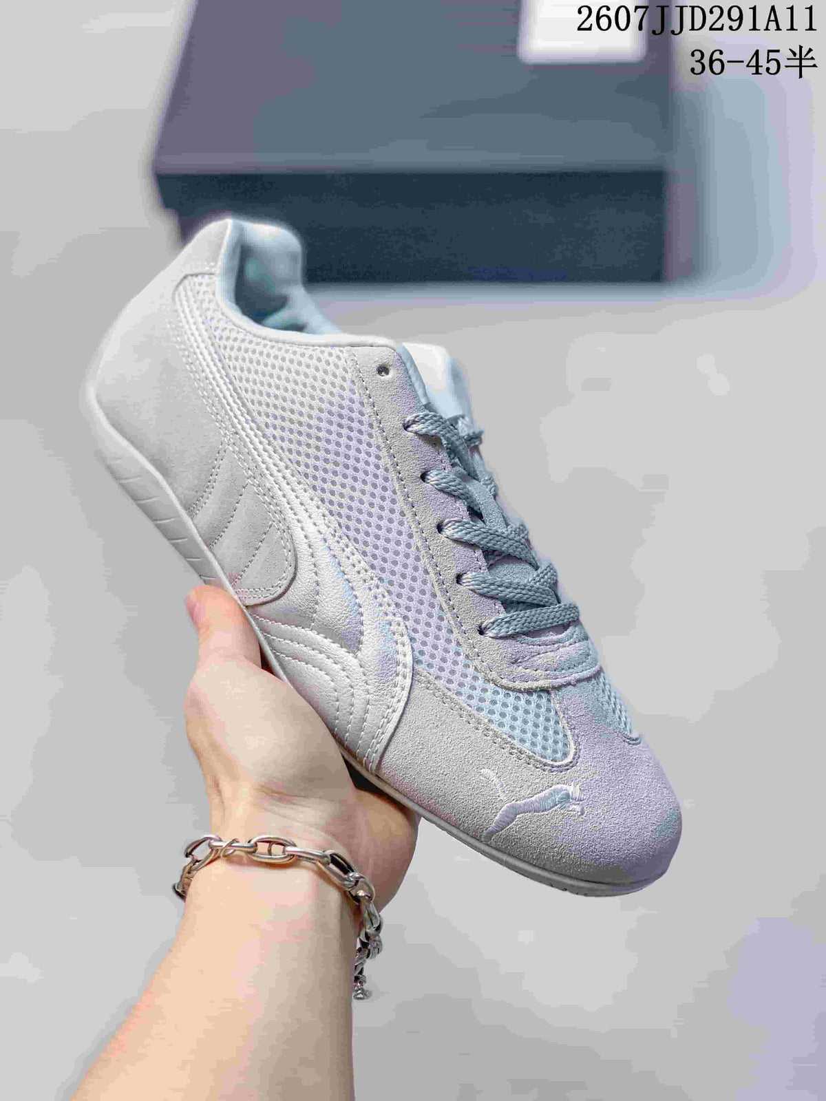 White and pale grey PUMA sneaker with mesh side panels, matching laces, and a light outsole.