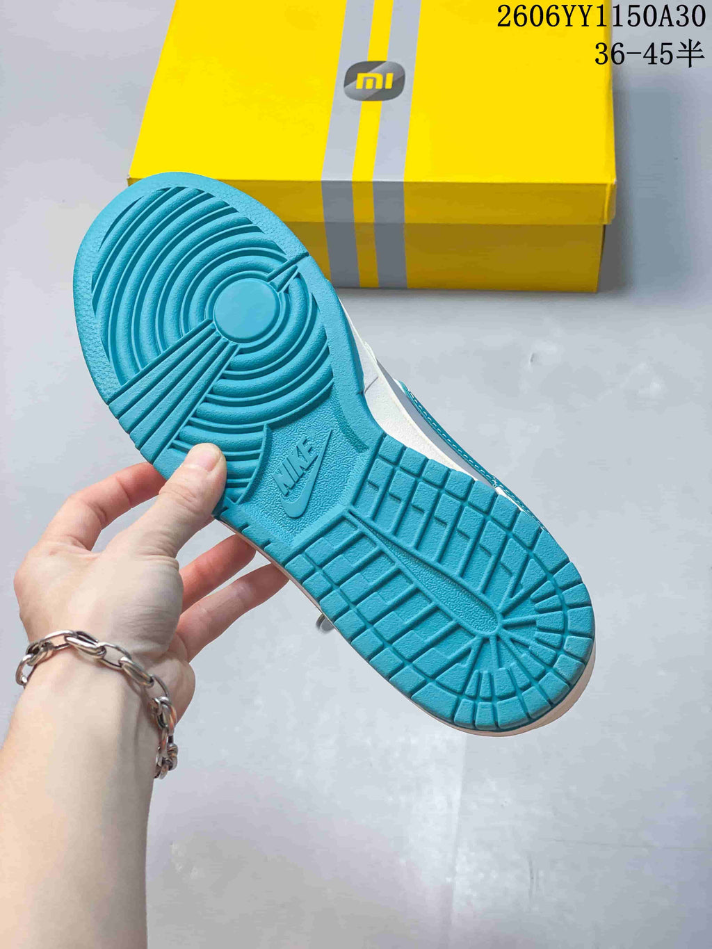 Turquoise sneaker outsole with circular tread pattern.