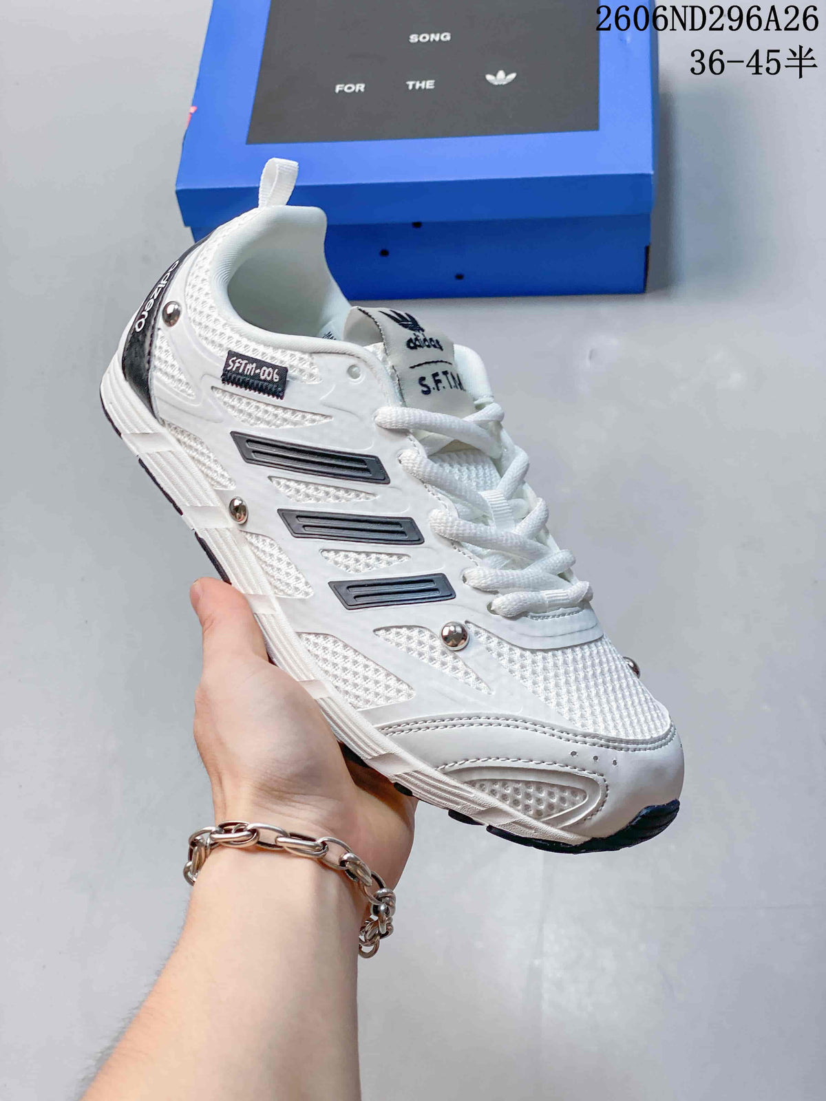 White Adidas SFTM-006 low-top sneaker with dark accent stripes and a dark outsole.