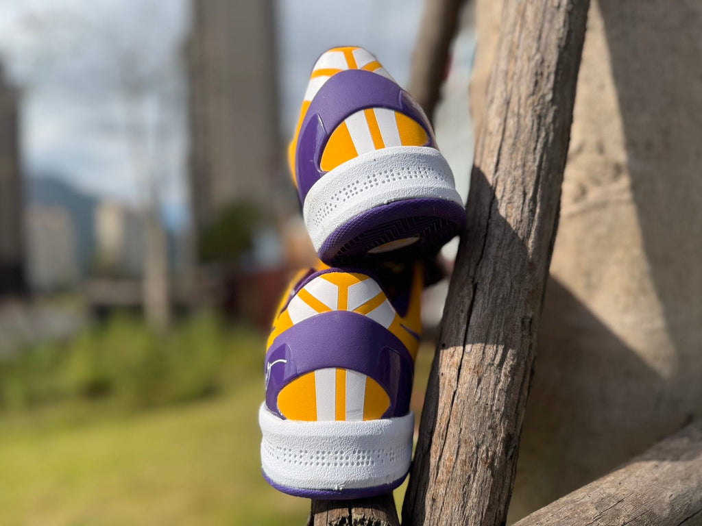 Rear heel view of the gold and purple Kobe 8 shoes