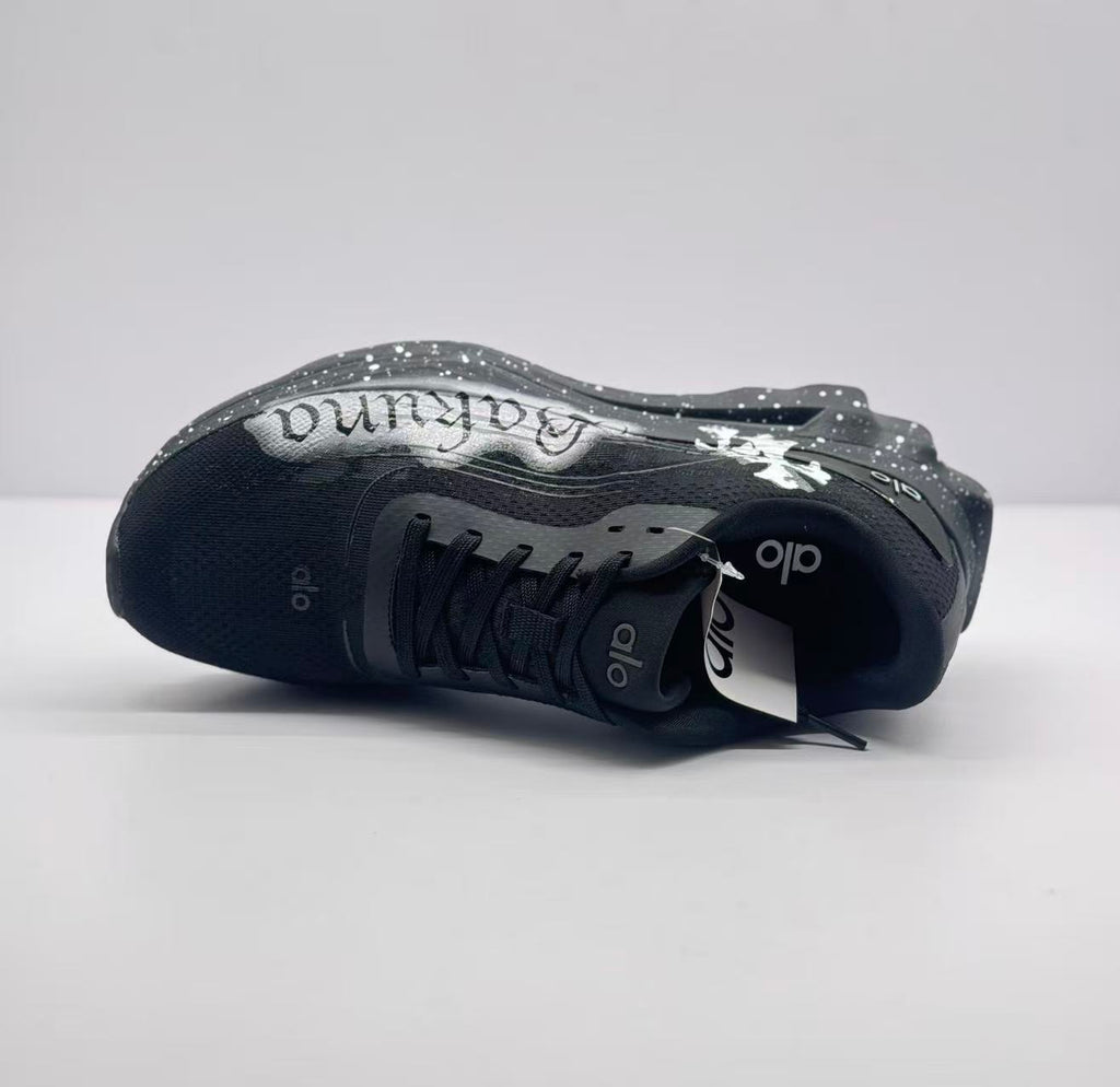 Top-down side view showing the black upper, lace area, tongue branding and graffiti panel.