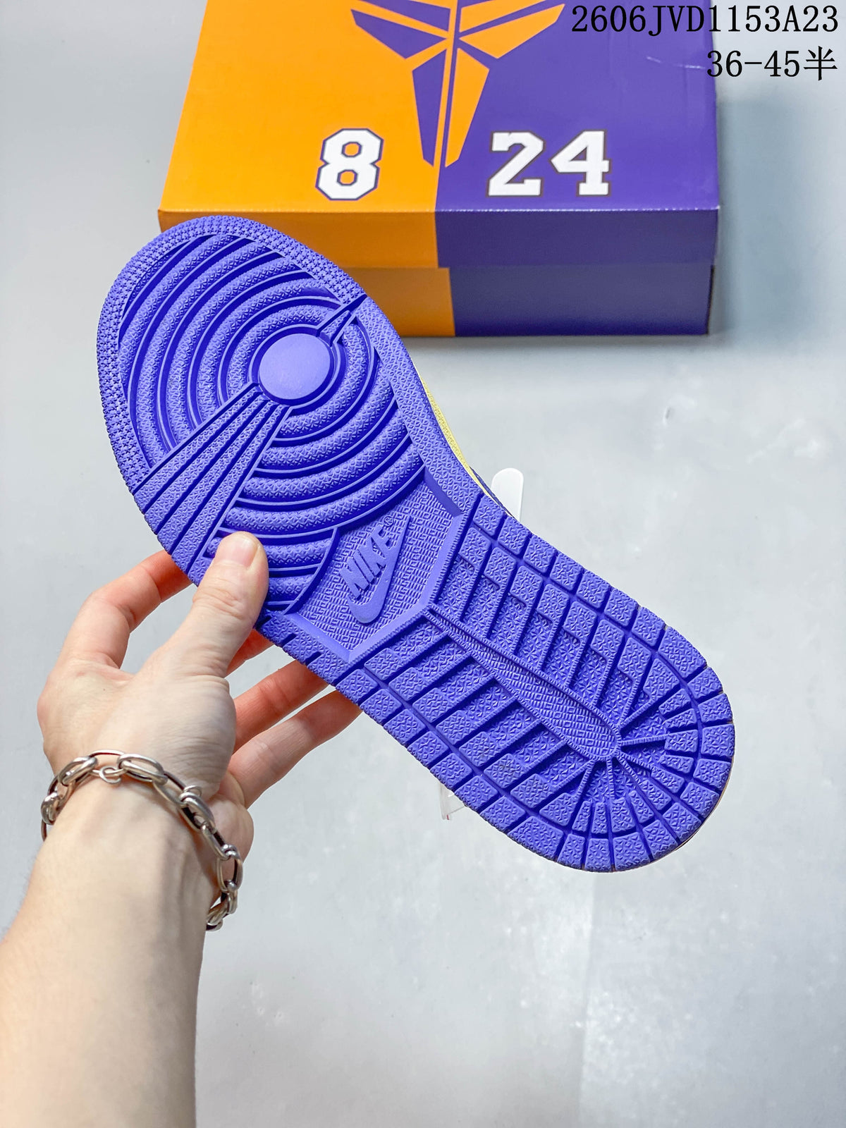 Close-up of the purple outsole on a yellow sneaker