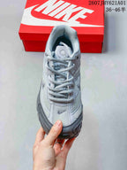 Front view showing the laces, mesh panels, and layered upper