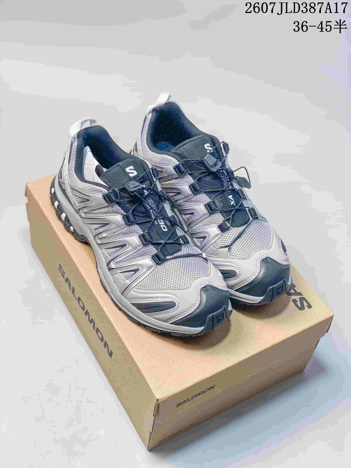 Silver and white Salomon XA PRO 3D sneakers with lime accents displayed on a shoebox from a front three-quarter angle.