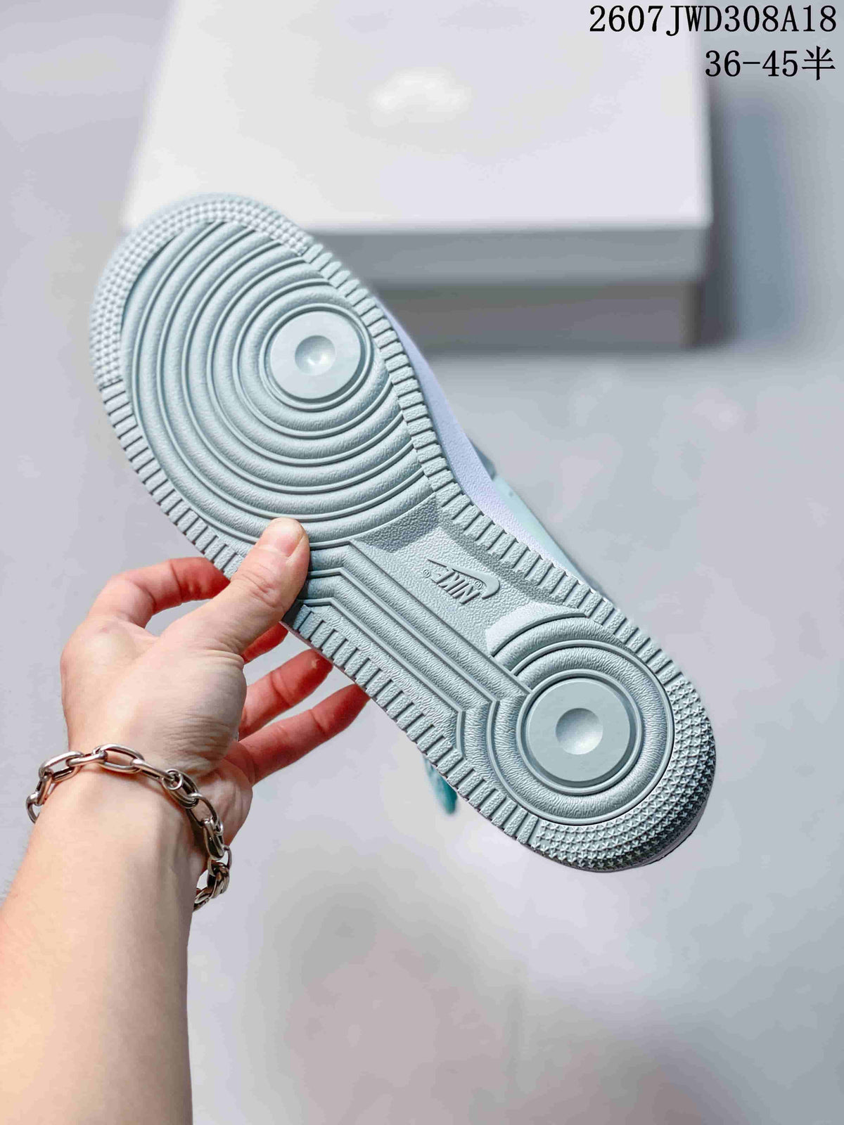Close view of the textured rubber outsole with circular traction patterns and Nike branding.