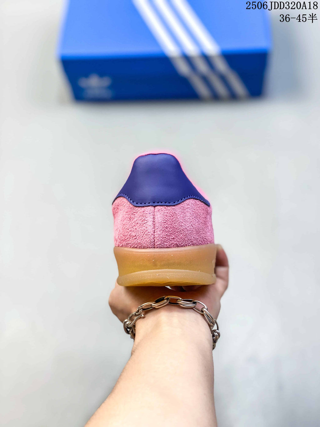 Rear view showing the pink textured upper, dark heel accent and translucent gum-colored sole.