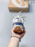 Rear view showing the padded heel, blue accent panel and gum-colored outsole.