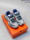 Pair of black, grey and white Nike Initiator sneakers displayed on an orange shoebox.