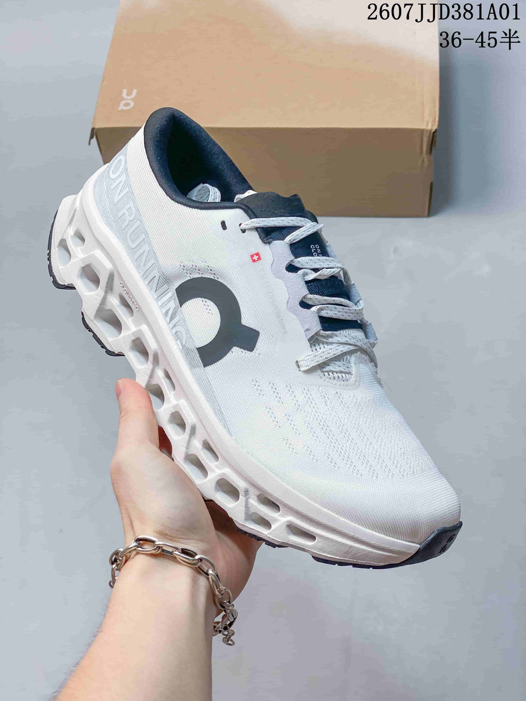 Angled side view of the white and navy running shoe