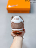 Rear view of the brown sneaker showing the white Nike heel detail, layered sole, and gum-colored outsole.