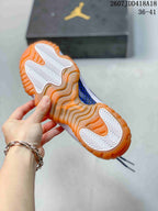 Close view of the sneaker outsole with white traction sections and a translucent orange rubber perimeter.
