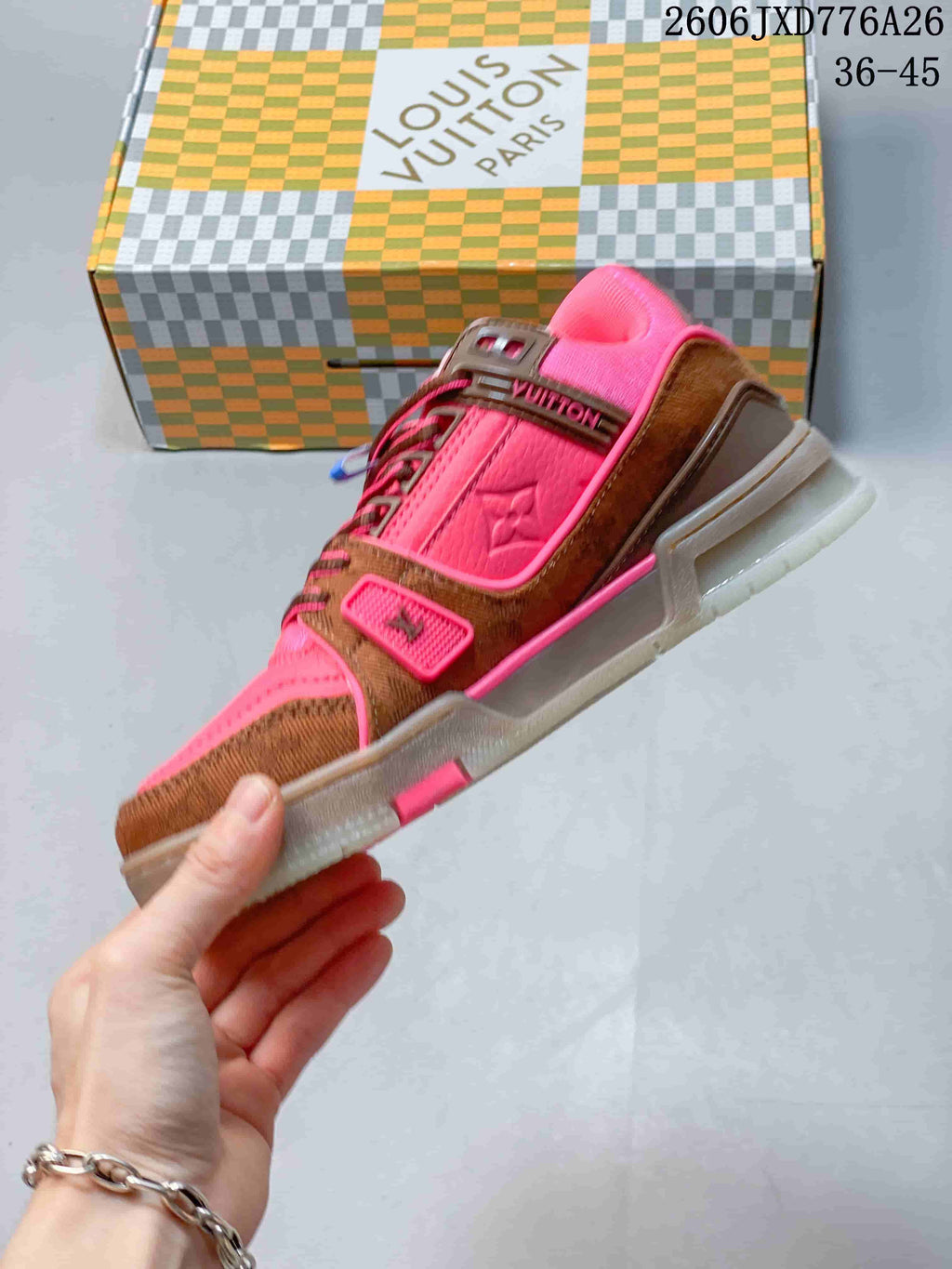 Side view of the pink and brown low-top sneaker with lace-up fastening