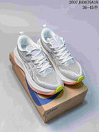 Pair of gray and white ASICS Superblast 2 Paris running shoes with coral and lime accents displayed on an ASICS shoe box.