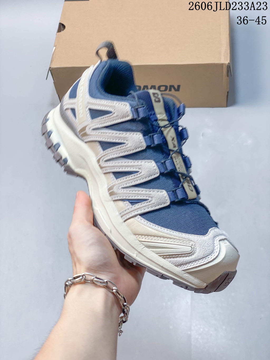 Angled side view of the blue and light neutral Salomon XA Pro 3D Suede shoe