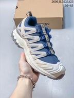 Angled side view of the blue and light neutral Salomon XA Pro 3D Suede shoe