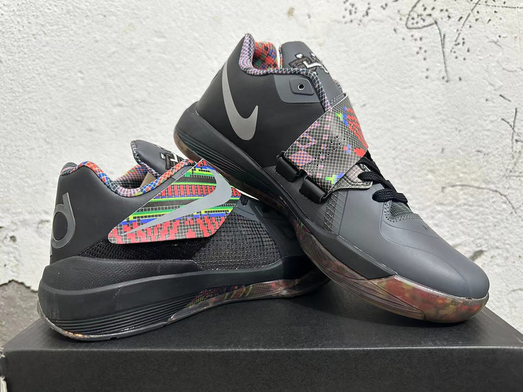 Basketball shoes displayed at an angle, showing the midfoot strap, multicolor accents, and translucent-looking outsole.