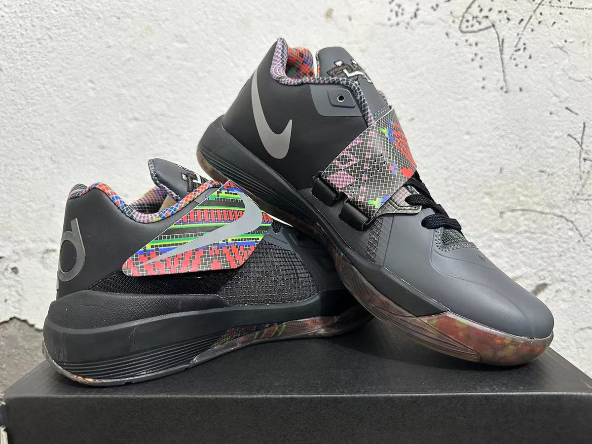 Basketball shoes displayed at an angle, showing the midfoot strap, multicolor accents, and translucent-looking outsole.