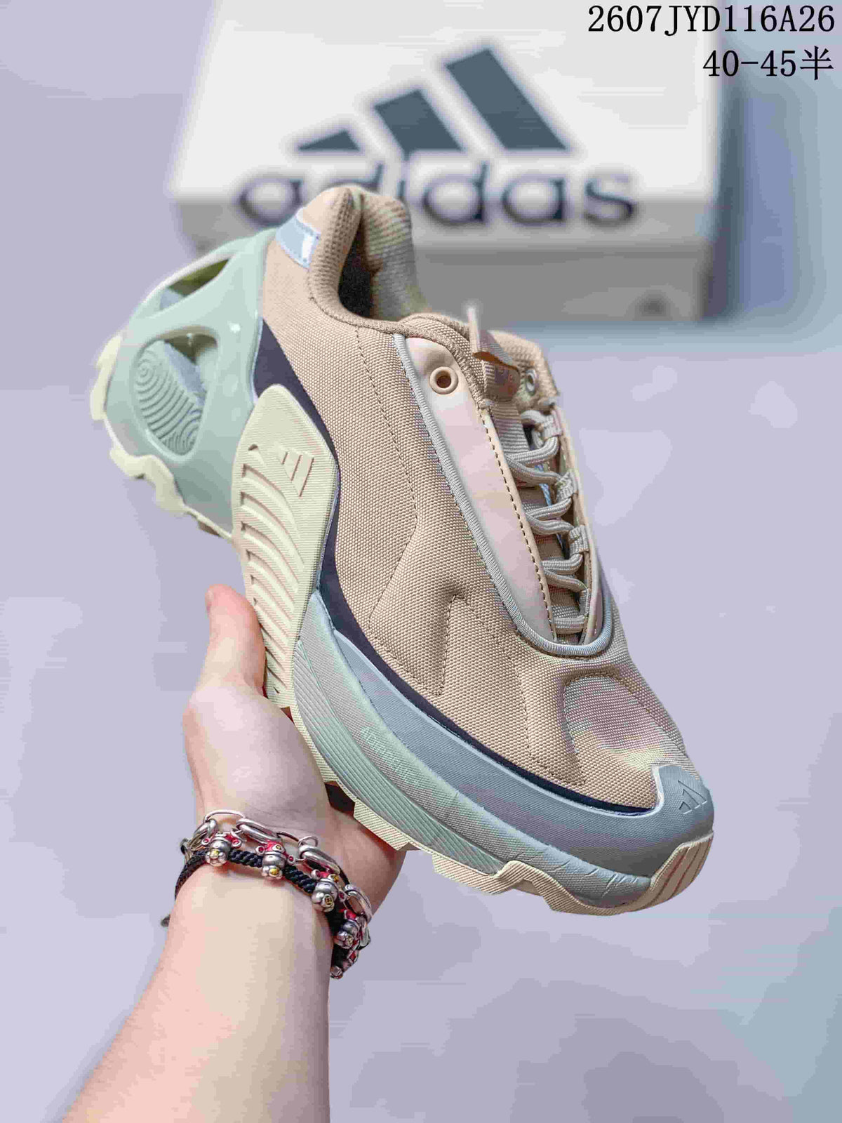Three-quarter front view showing the beige upper, mint and gray sole layers, laces and toe design.
