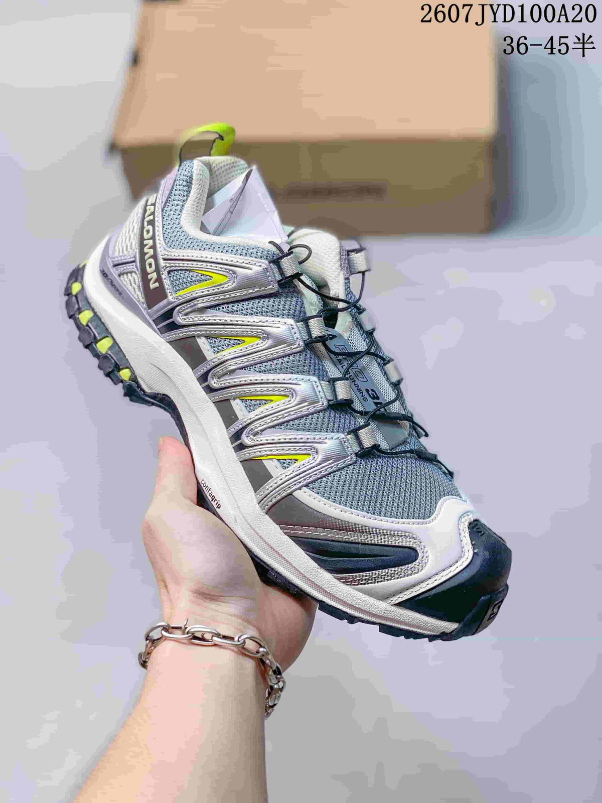 Gray and white Salomon XA PRO 3D trail shoe with bright yellow accents and a dark outsole.