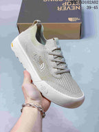 Close-up of a light gray knit-look The North Face Dune sneaker with lace-up front and contrasting sole.
