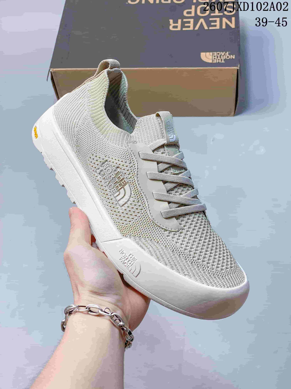 Close-up of a light gray knit-look The North Face Dune sneaker with lace-up front and contrasting sole.