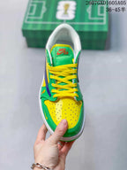 Top view showing the yellow perforated toe box, green overlays and yellow laces.