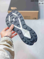 Close-up of the black rubber outsole showing a lugged traction pattern and white central structure.