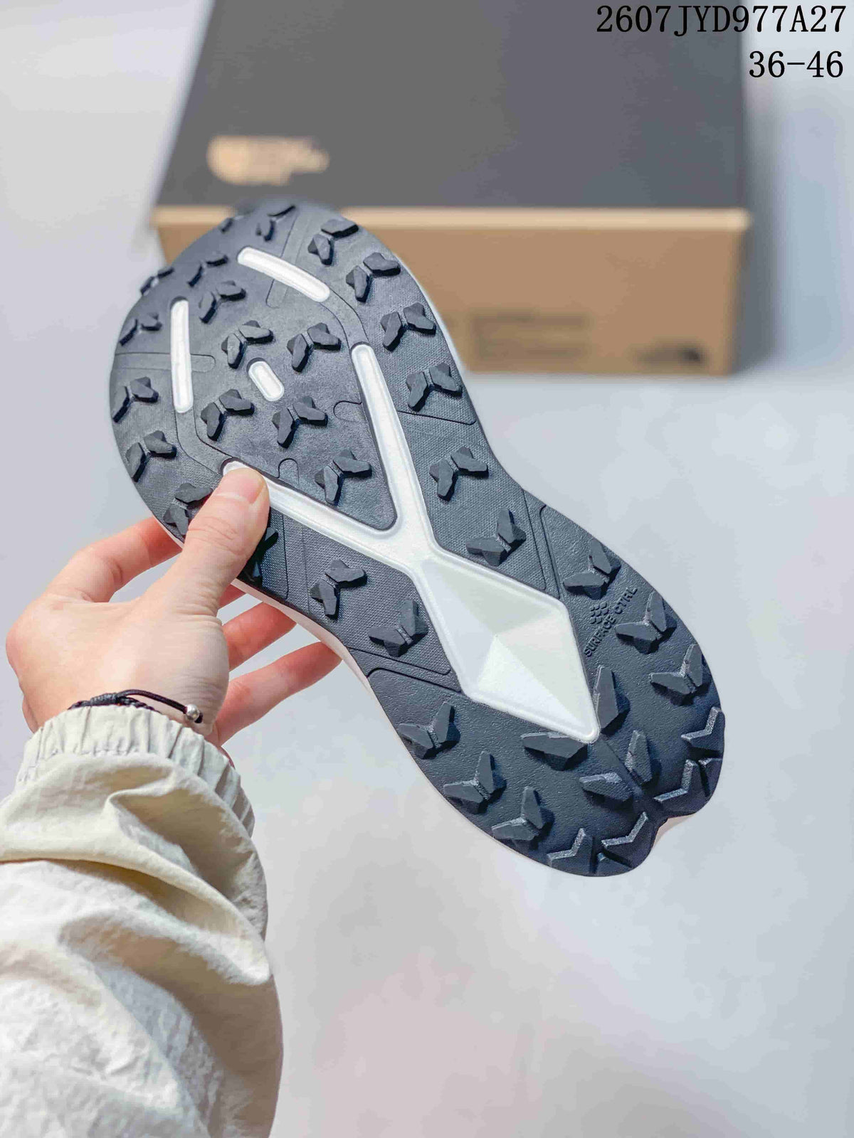 Close-up of the black rubber outsole showing a lugged traction pattern and white central structure.