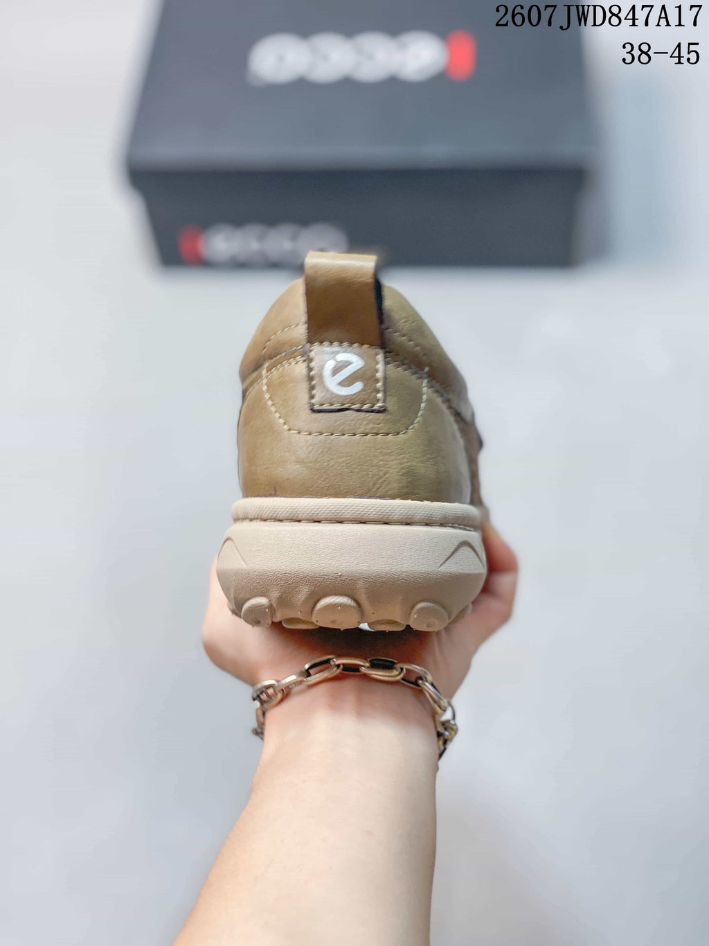 Rear view of an ECCO slip-on sneaker showing the heel pull tab, stitched heel panel, and outsole profile.