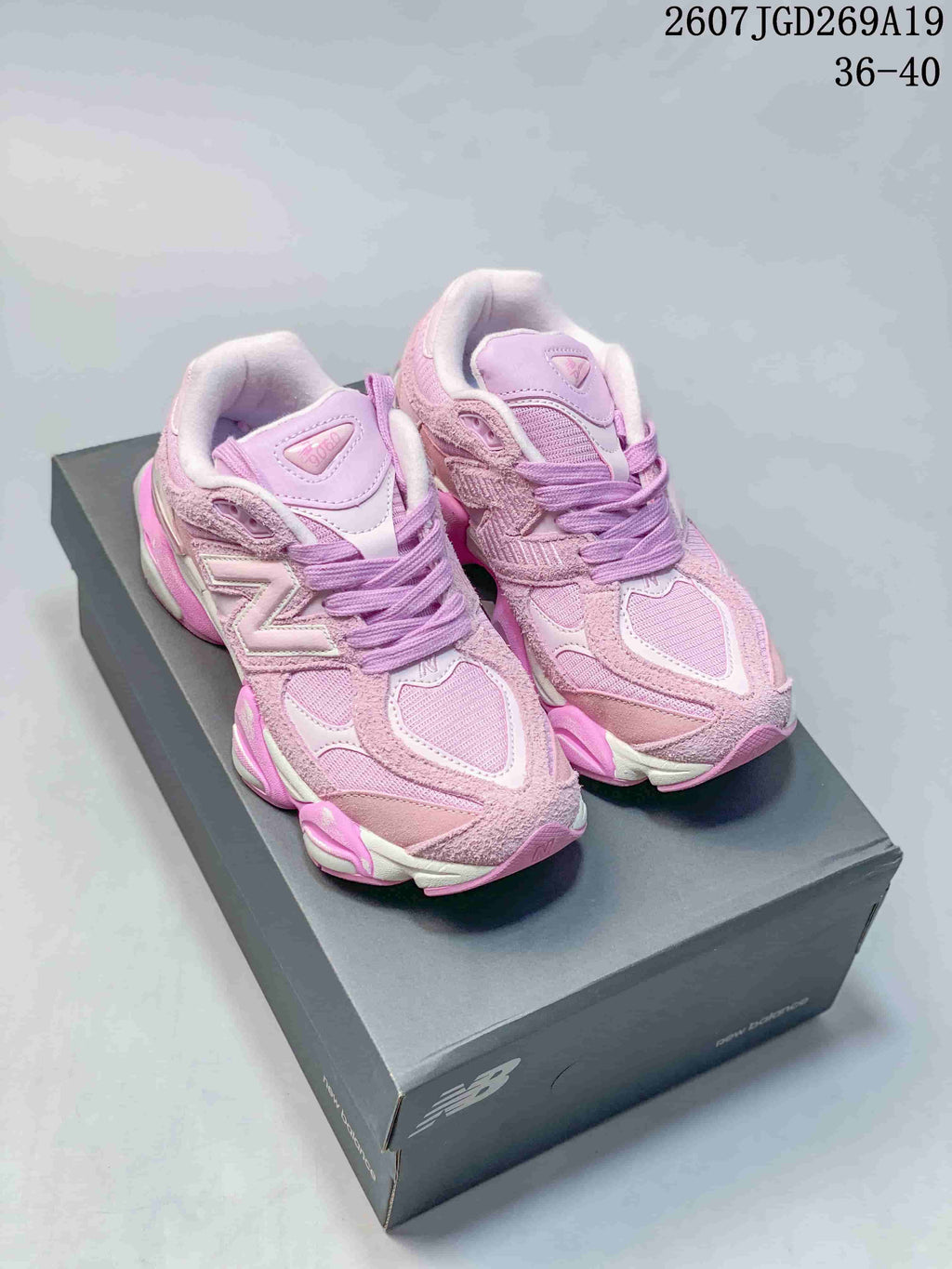 Pair of pink and lilac New Balance 9060 sneakers shown on a shoebox, with the listed size range 36–40 visible in the upper-right corner.
