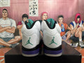 Rear view of white high-top sneakers with teal heel logos and purple heel accents