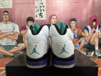 Rear view of white high-top sneakers with teal heel logos and purple heel accents