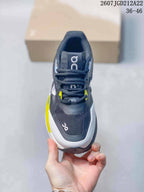 Top view showing the black lace-up upper, tongue branding, white toe trim, and yellow accents.