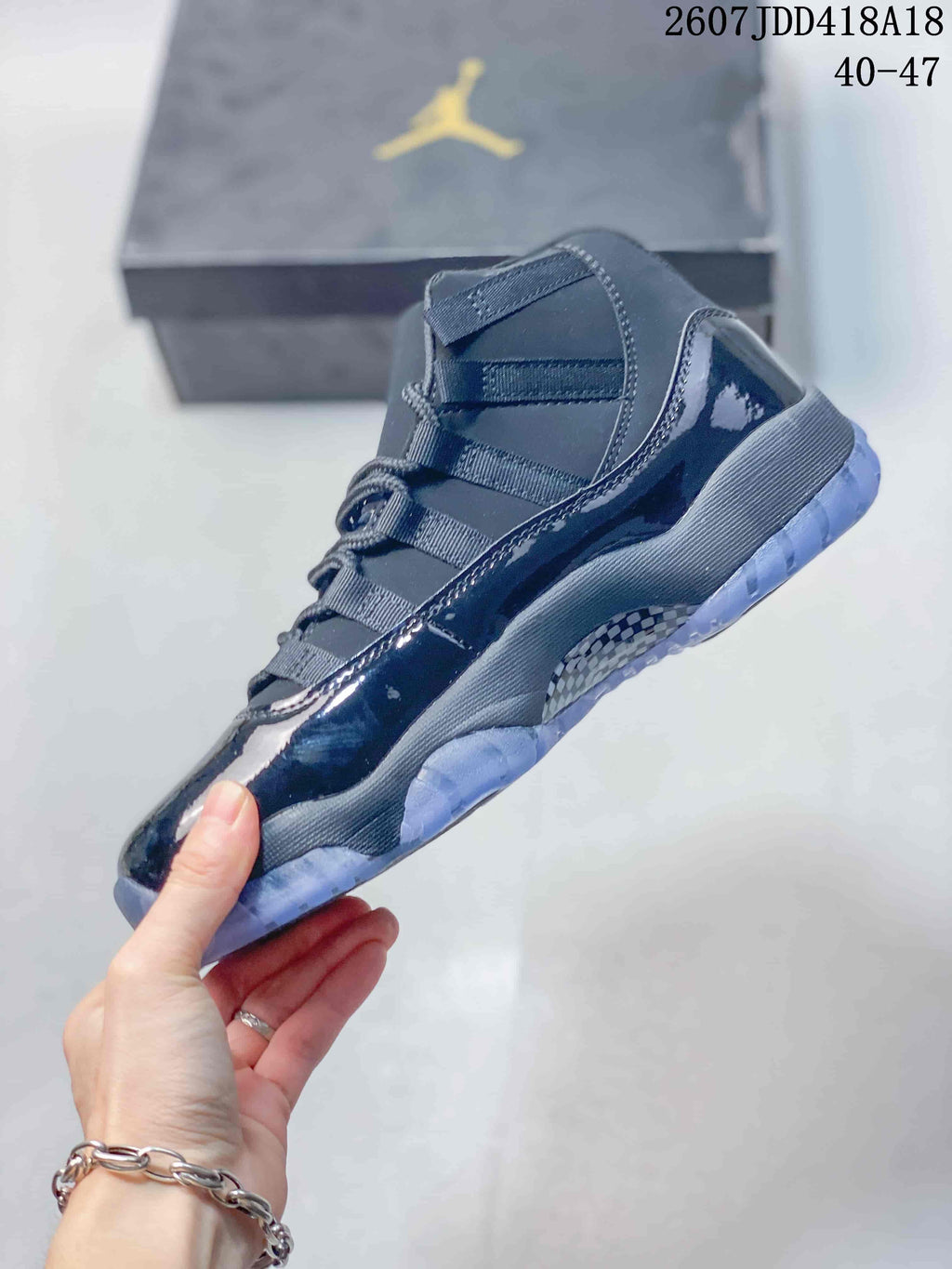 Side view of the dark high-top sneaker showing its glossy overlays, layered upper and translucent outsole.