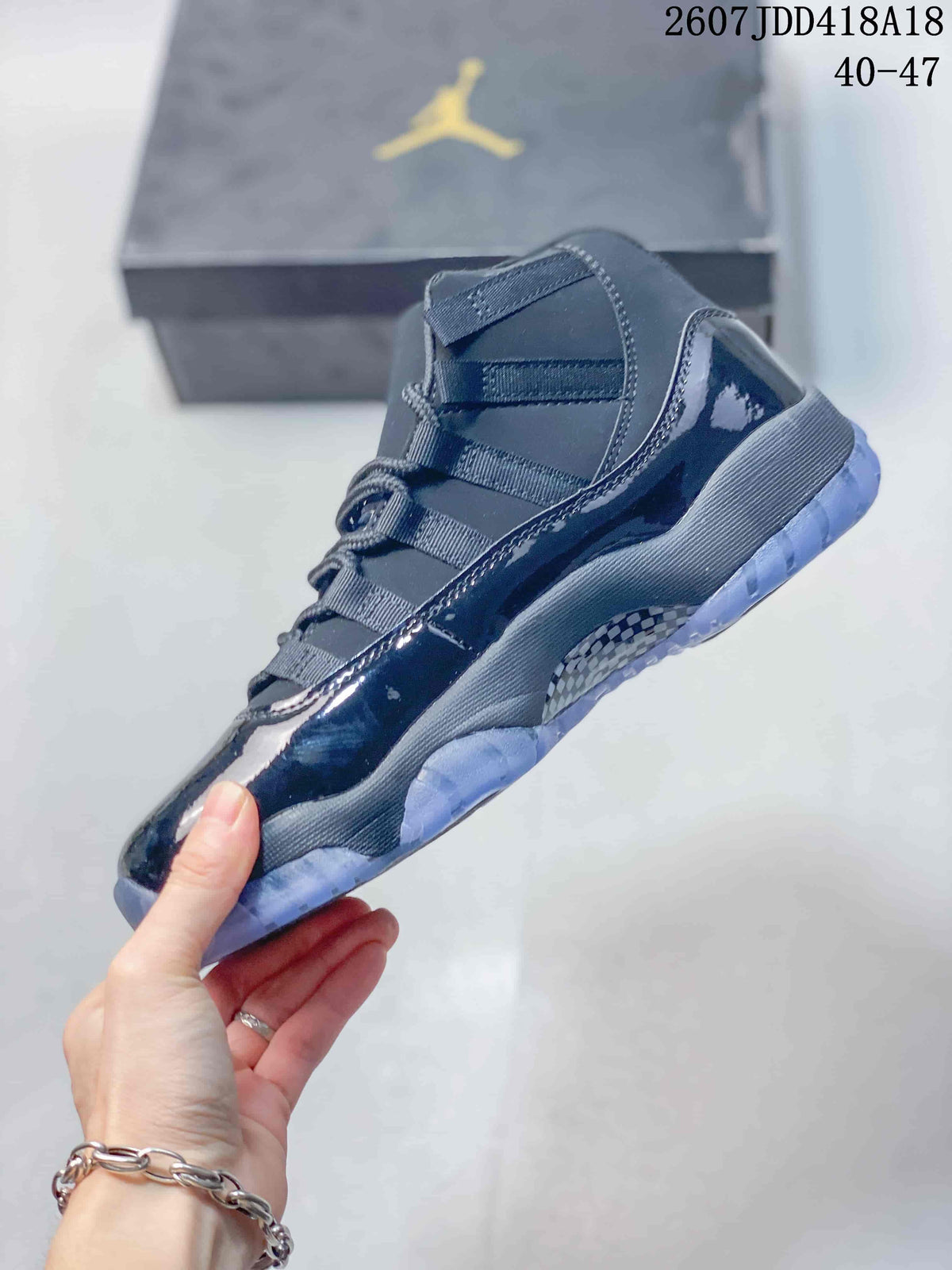 Side view of the dark high-top sneaker showing its glossy overlays, layered upper and translucent outsole.