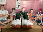 Front view of the white Mizuno Wave Momentum 3 shoes showing dark green laces and gum-colored toe sections