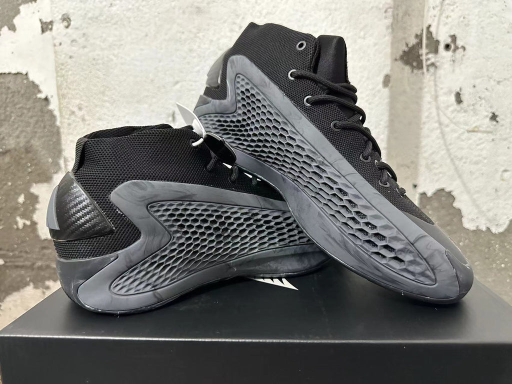 Two black high-top sneakers displayed at an angle, showing their textured side panels and lace-up fronts.